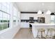 Open kitchen features a large island, modern appliances, and ample natural light, perfect for entertaining at 3279 Morab Dr, Zionsville, IN 46077