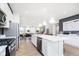 Bright, open kitchen featuring a large island, stainless steel appliances, and seamlessly flowing into the dining and living areas at 3279 Morab Dr, Zionsville, IN 46077