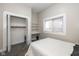 Bright bedroom featuring built in shelving, closet, and large window at 33 N Beville Ave, Indianapolis, IN 46201