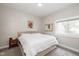 Comfortable bedroom with neutral tones, cozy carpet, and a bright window at 33 N Beville Ave, Indianapolis, IN 46201