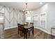 Open dining area with a modern light fixture and decorative accent wall at 33 N Beville Ave, Indianapolis, IN 46201