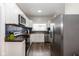 Contemporary kitchen with stainless steel appliances, dark wood counters, and subway tile backsplash at 33 N Beville Ave, Indianapolis, IN 46201