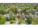 Aerial view of the home showcasing lush landscaping, mature trees, and surrounding neighborhood at 333 N Kenyon St, Indianapolis, IN 46219