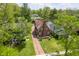 Aerial front view of the home with brick driveway, and mature landscaping, mature trees, and surrounding neighborhood at 333 N Kenyon St, Indianapolis, IN 46219