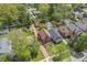 Aerial view of the property highlighting the roof, driveway, landscaping, mature trees and surrounding neighborhood at 333 N Kenyon St, Indianapolis, IN 46219