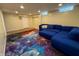 Finished basement area with comfortable seating and decorative carpet at 333 N Kenyon St, Indianapolis, IN 46219