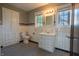 Classic bathroom with black and white checkered floors, tiled walls, and vintage-style fixtures at 333 N Kenyon St, Indianapolis, IN 46219