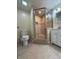 Bathroom featuring tiled shower with glass door, a toilet, and a modern sink at 333 N Kenyon St, Indianapolis, IN 46219