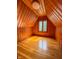 Attic bedroom featuring natural lighting, wooden paneling, and hardwood floors at 333 N Kenyon St, Indianapolis, IN 46219