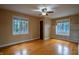 Cozy bedroom with hardwood floors, a ceiling fan, and built-in shelving for ample storage at 333 N Kenyon St, Indianapolis, IN 46219
