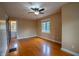 Inviting bedroom with hardwood floors, a ceiling fan, and lots of natural light through large windows at 333 N Kenyon St, Indianapolis, IN 46219