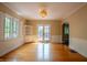 Bright dining room with hardwood floors, built-in shelving, and double doors to the outdoor deck at 333 N Kenyon St, Indianapolis, IN 46219