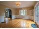 Open dining room area with hardwood floors, built-in shelving, and elegant archway leading to living area at 333 N Kenyon St, Indianapolis, IN 46219