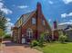 Beautiful brick home with a well-manicured lawn and a long driveway leading up to the property at 333 N Kenyon St, Indianapolis, IN 46219