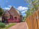 Brick home featuring a private deck and a long driveway leading to the back of the property at 333 N Kenyon St, Indianapolis, IN 46219