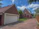 Spacious two-car garage and a charming brick home connected by a long driveway at 333 N Kenyon St, Indianapolis, IN 46219
