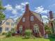 Charming two-story brick home featuring a classic architectural design and well-maintained landscaping at 333 N Kenyon St, Indianapolis, IN 46219