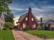Inviting brick home with warm exterior lighting and a well-kept front yard at 333 N Kenyon St, Indianapolis, IN 46219