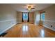 Spacious living room featuring hardwood floors, a ceiling fan and two large windows offering plenty of natural light at 333 N Kenyon St, Indianapolis, IN 46219
