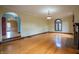 Spacious living room with hardwood floors, arched doorway, and fireplace at 333 N Kenyon St, Indianapolis, IN 46219