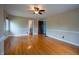 Bright living room showcasing pristine hardwood floors, a ceiling fan, and an open doorway at 333 N Kenyon St, Indianapolis, IN 46219