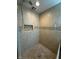 Tiled shower with a tiled shower floor, a shower head, and a built in shelf at 333 N Kenyon St, Indianapolis, IN 46219