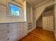Organized walk-in closet with custom shelving, drawers, and a window for natural light at 333 N Kenyon St, Indianapolis, IN 46219