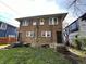 Back view of the two-story brick home, showcasing its functional rear entrances at 3443 Broadway St, Indianapolis, IN 46205