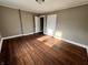 Bedroom featuring hardwood floors, two closets, and ample natural light at 3443 Broadway St, Indianapolis, IN 46205