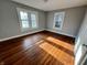Comfortable bedroom featuring hardwood floors, neutral wall colors and a bright, airy atmosphere at 3443 Broadway St, Indianapolis, IN 46205