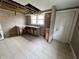 Kitchen showing the cabinets, sink, window, and door leading outside at 3443 Broadway St, Indianapolis, IN 46205