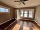 Bright living room featuring hardwood floors, large windows, and a ceiling fan at 3443 Broadway St, Indianapolis, IN 46205