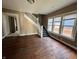 Spacious living room with hardwood floors and a staircase leading to the upper level at 3443 Broadway St, Indianapolis, IN 46205