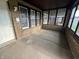 Enclosed front porch with brick walls and multi-pane windows, providing a cozy entrance at 3443 Broadway St, Indianapolis, IN 46205