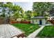 View of the backyard with detached garage and new wood fence and stone patio at 357 N Kenyon St, Indianapolis, IN 46219