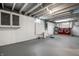 Unfinished basement with painted walls, exposed ceiling, and red washer and dryer set at 357 N Kenyon St, Indianapolis, IN 46219