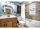 Cozy bathroom featuring a tub, wooden vanity, and great lighting at 357 N Kenyon St, Indianapolis, IN 46219
