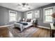 Spacious bedroom with hardwood floors, large windows, and a ceiling fan at 357 N Kenyon St, Indianapolis, IN 46219