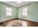 The bedroom features green walls and two large windows that provide great natural light at 357 N Kenyon St, Indianapolis, IN 46219