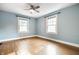 The bedroom features blue walls and two large windows that provide great natural light at 357 N Kenyon St, Indianapolis, IN 46219