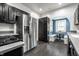 This kitchen features stainless steel appliances, black cabinets, and lots of storage space at 357 N Kenyon St, Indianapolis, IN 46219