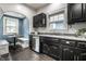 This kitchen features black cabinets, stainless steel appliances, and a cozy breakfast nook at 357 N Kenyon St, Indianapolis, IN 46219