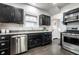 This kitchen features black cabinets, stainless steel appliances, and ample counter space at 357 N Kenyon St, Indianapolis, IN 46219
