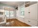 Cozy living area featuring hardwood floors, white built-in cabinets, and a view of the outdoors at 357 N Kenyon St, Indianapolis, IN 46219