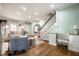 Open-concept living room with fireplace, staircase, desk, and hardwood flooring at 357 N Kenyon St, Indianapolis, IN 46219