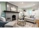 Inviting living room with fireplace, plush seating, hardwood floors, and built-in shelves at 357 N Kenyon St, Indianapolis, IN 46219
