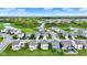 Scenic aerial view of a residential neighborhood featuring a pond, green spaces, and tree-lined streets at 3719 Lexham Ct, Danville, IN 46122