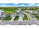 Aerial view of homes in a neighborhood with landscaping, surrounded by green spaces at 3719 Lexham Ct, Danville, IN 46122