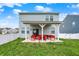 Backyard featuring a cozy covered patio with red seating at 3719 Lexham Ct, Danville, IN 46122