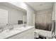 Well-lit bathroom featuring a dual sink vanity with quartz countertops and a shower-tub combo at 3719 Lexham Ct, Danville, IN 46122
